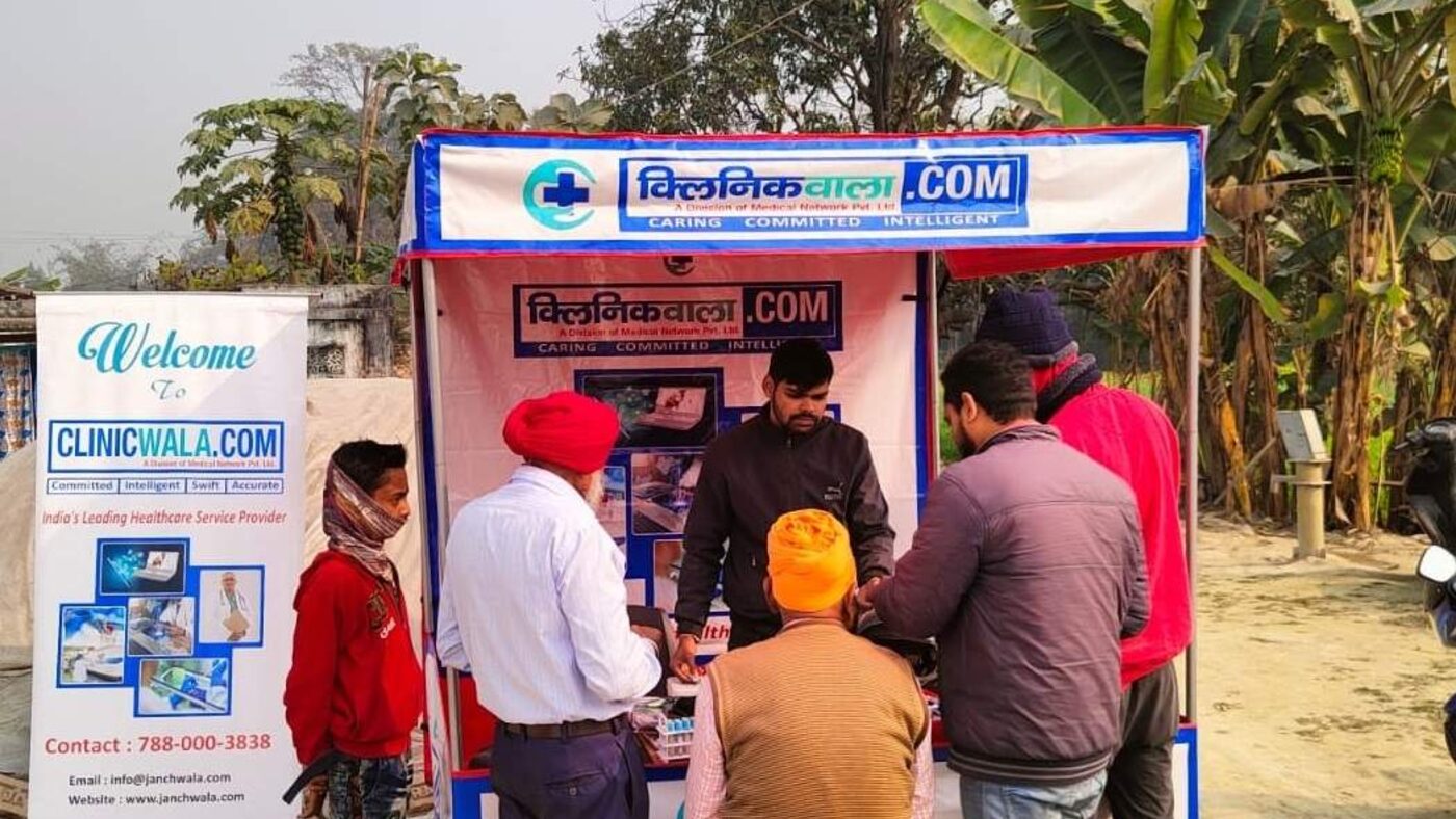 ClinicWala staff attending patients at an open-air rural health camp